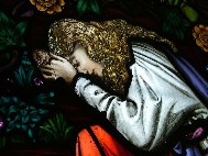 Mary of Magdala weeps at the foot of the cross