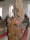 St Andrew holds a cross inthe niche; the sin above is Avarice